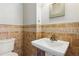 Bathroom with a pedestal sink and decorative tile at 972 Oakley Ln, Sugar Hill, GA 30518