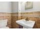 Compact bathroom featuring a modern sink and neutral-toned tiling at 972 Oakley Ln, Sugar Hill, GA 30518