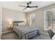 Cozy bedroom featuring neutral walls, carpet, two windows, and a ceiling fan at 972 Oakley Ln, Sugar Hill, GA 30518