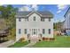 Charming two-story home with gray siding, new roof, and a well-manicured lawn at 972 Oakley Ln, Sugar Hill, GA 30518