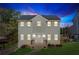 Charming two-story home with gray siding, a new roof, and landscaped lawn at dusk at 972 Oakley Ln, Sugar Hill, GA 30518