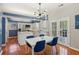 Bright kitchen with an island, white cabinets, stainless steel appliances, and an adjacent dining area at 972 Oakley Ln, Sugar Hill, GA 30518