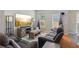 Living room featuring modern furnishings, large windows for natural light, and a TV above a console at 972 Oakley Ln, Sugar Hill, GA 30518