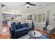 Cozy living room with a blue sofa, hardwood floors, and an open layout flowing into the kitchen at 972 Oakley Ln, Sugar Hill, GA 30518