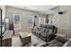 Comfortable living room featuring large windows, cozy furniture, neutral walls, and direct staircase access at 972 Oakley Ln, Sugar Hill, GA 30518