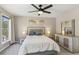 Serene main bedroom with a king-sized bed, dresser, and bedside tables with lamps, offering a relaxing retreat at 972 Oakley Ln, Sugar Hill, GA 30518