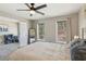 Cozy main bedroom featuring a king-sized bed, plush bedding, and an open doorway to another room at 972 Oakley Ln, Sugar Hill, GA 30518