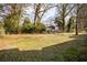 Large backyard with mature trees and partial fencing at 1388 Willow Sw Trl, Atlanta, GA 30311