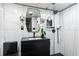 Modern bathroom with a black vanity, sleek fixtures, a walk-in shower, and contemporary tile design at 1388 Willow Sw Trl, Atlanta, GA 30311