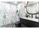 Modern bathroom featuring marble walls, a sleek vanity, and contemporary fixtures at 1388 Willow Sw Trl, Atlanta, GA 30311