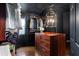 Custom walk-in closet with wooden shelving, hanging racks, a statement chandelier, and an island dresser at 1388 Willow Sw Trl, Atlanta, GA 30311