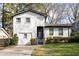 Charming exterior of a home with white brick, fresh black trim, and green landscaping at 1388 Willow Sw Trl, Atlanta, GA 30311