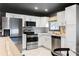 Bright kitchen with stainless steel appliances, white cabinets, and modern countertops at 1388 Willow Sw Trl, Atlanta, GA 30311