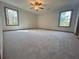 Spacious bedroom with neutral carpet, a ceiling fan, and two windows at 3825 Emerson St, Marietta, GA 30062