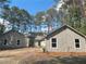 Charming home with neutral siding, complemented by lush landscaping and mature trees at 3825 Emerson St, Marietta, GA 30062