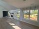 Bright living room with a fireplace, new flooring, and large windows at 3825 Emerson St, Marietta, GA 30062