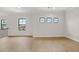 Upstairs bonus room featuring hardwood floors, neutral walls, and abundant natural light at 5424 Gallagher Ct, Powder Springs, GA 30127