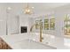 Stylish kitchen featuring a large island, quartz countertops, and an open view of the living area at 5424 Gallagher Ct, Powder Springs, GA 30127