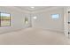 Large main bedroom with three windows, tray ceilings, and plush carpeting creating a peaceful retreat at 5424 Gallagher Ct, Powder Springs, GA 30127