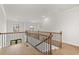 Upstairs hallway showcasing hardwood floors, iron railing, and natural light at 5424 Gallagher Ct, Powder Springs, GA 30127
