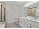 Modern bathroom featuring double vanity, stylish tile, and glass-enclosed shower, offering a spa-like experience at 5915 Pinnacle View Rd, Cumming, GA 30040