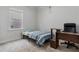 Cozy bedroom with a bed, desk, and large window providing natural light at 5915 Pinnacle View Rd, Cumming, GA 30040