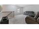 Bright bonus room featuring plush carpet, ample seating, and modern entertainment center at 5915 Pinnacle View Rd, Cumming, GA 30040