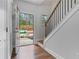 Inviting entryway with hardwood floors, a staircase, and a view of the front yard at 5915 Pinnacle View Rd, Cumming, GA 30040