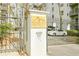 Community entrance sign at Lenox Villas with a gate and warning sign for vehicles entering the property at 970 Sidney Marcus Ne Blvd # 1208, Atlanta, GA 30324