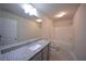 Well-lit bathroom showcasing a granite vanity, sleek fixtures, and a shower-tub combo, providing modern convenience at 2551 Bear Mountain St, Lithonia, GA 30058