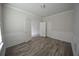 Clean bedroom with hardwood floors, white trim, and multiple doors at 2551 Bear Mountain St, Lithonia, GA 30058