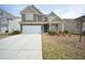 Charming two-story home with a two-car garage, covered porch, and manicured lawn at 2551 Bear Mountain St, Lithonia, GA 30058