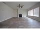 Spacious living room with a fireplace, ceiling fan, and lots of natural light from the windows at 2551 Bear Mountain St, Lithonia, GA 30058