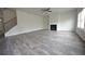 Spacious living area with gray flooring, fireplace, and an adjacent staircase at 2551 Bear Mountain St, Lithonia, GA 30058