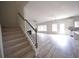 Bright living room features gray flooring, staircase, multiple windows, and an open layout at 2551 Bear Mountain St, Lithonia, GA 30058