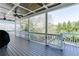 An expansive back porch with wood flooring, ceiling fans, and a beautiful view of the landscaped yard at 3268 Cates Ne Ave, Brookhaven, GA 30319