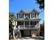 Two-story home featuring a welcoming front porch, neutral siding, craftsman-style details, and a garage at 3268 Cates Ne Ave, Brookhaven, GA 30319