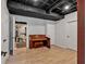 A piano sits in the open basement with wood floors at 3699 Fowler Rdg, Douglasville, GA 30135