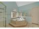 A bright bathroom features a corner jacuzzi tub, a shower, and decorative mirrors at 3699 Fowler Rdg, Douglasville, GA 30135