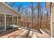 Wood deck leads to screened in porch surrounded by mature trees at 3699 Fowler Rdg, Douglasville, GA 30135