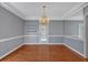 Dining room featuring hardwood floors, crown molding, and a decorative chandelier at 3699 Fowler Rdg, Douglasville, GA 30135