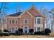 Charming two-story brick home featuring a blue front door and well-manicured landscaping at 3699 Fowler Rdg, Douglasville, GA 30135