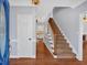 Inviting foyer with hardwood floors, staircase, and view into the bright kitchen at 3699 Fowler Rdg, Douglasville, GA 30135