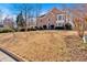 Expansive front yard showcases a two-story brick home with classic architectural details at 3699 Fowler Rdg, Douglasville, GA 30135