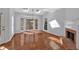 Sunlit living room with skylights, a brick fireplace, and hardwood floors at 3699 Fowler Rdg, Douglasville, GA 30135