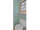 Powder room with toilet, chair rail, and window at 3699 Fowler Rdg, Douglasville, GA 30135