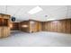 The basement features wood-look wall paneling, carpet, a drop ceiling, and a pass-through window at 50 Stonington Pl, Marietta, GA 30068