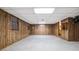 Spacious basement area featuring wood paneling and a light gray carpet at 50 Stonington Pl, Marietta, GA 30068