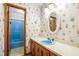 This bathroom features a blue sink and tub, and seashell wallpaper at 50 Stonington Pl, Marietta, GA 30068