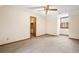 This bedroom features light-colored walls and carpet, trim, ceiling fan, closet, and a window at 50 Stonington Pl, Marietta, GA 30068